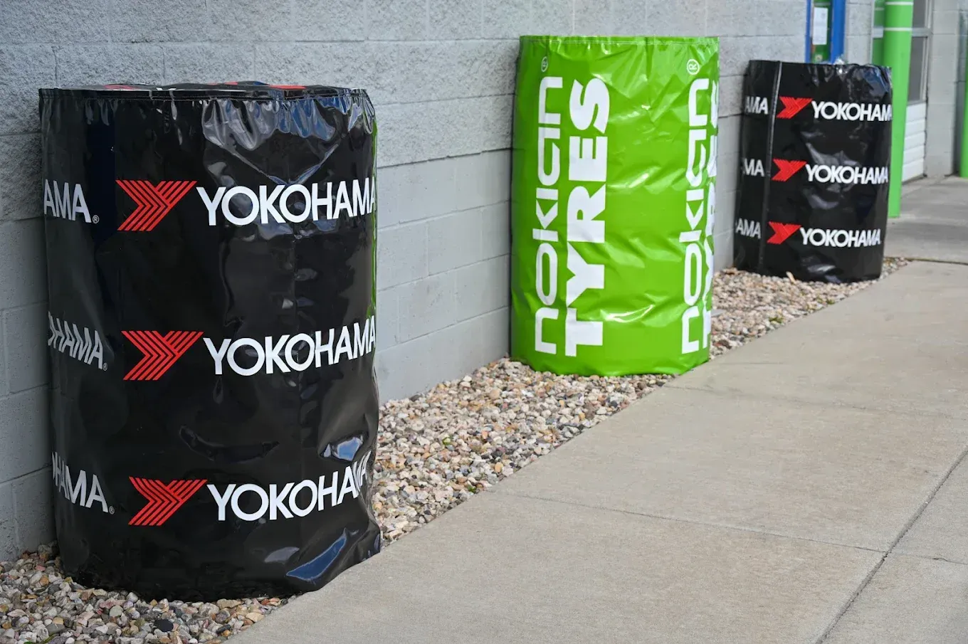 Yokohama and Nokian tires displayed as outdoor barriers along a sidewalk | Jones Complete Car Care