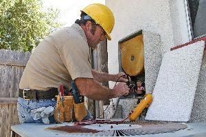 Man Repairing Air Conditioning Unit — Vashon, WA — Vashon Heating & Cooling Man Repairing Air Conditioning Unit — Vashon, WA — Vashon Heating & Cooling