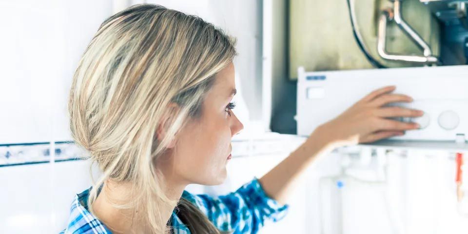 Woman Checking Boiler System — Vashon, WA — Vashon Heating & Cooling Woman Checking Boiler System — Vashon, WA — Vashon Heating & Cooling