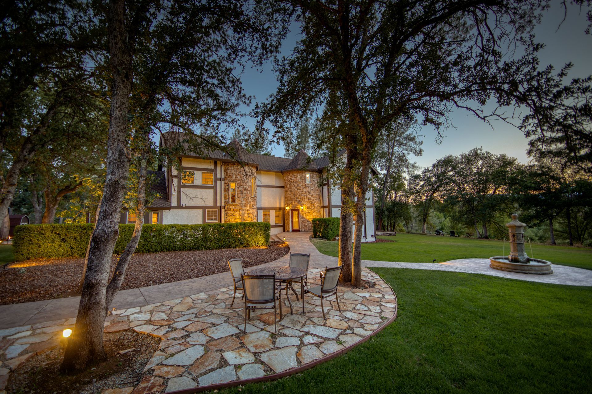 A large house with a patio area in front of it.
