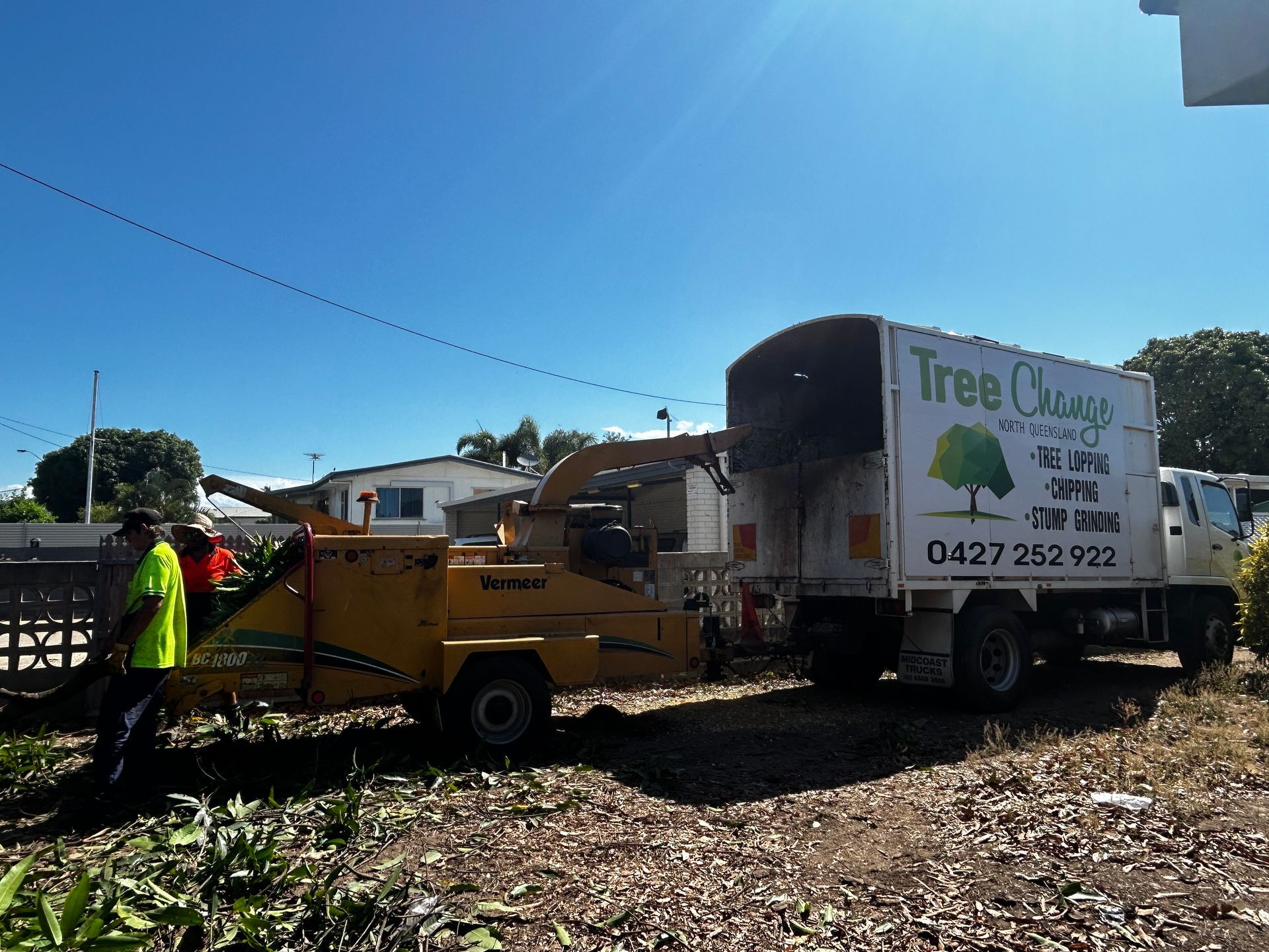 Tree Change Branded Truck and Wood Chipper Machine on a Tree Lopping Job Site With a Worker in High-vis Vest — Tree Change NQ in Townsville, QLD