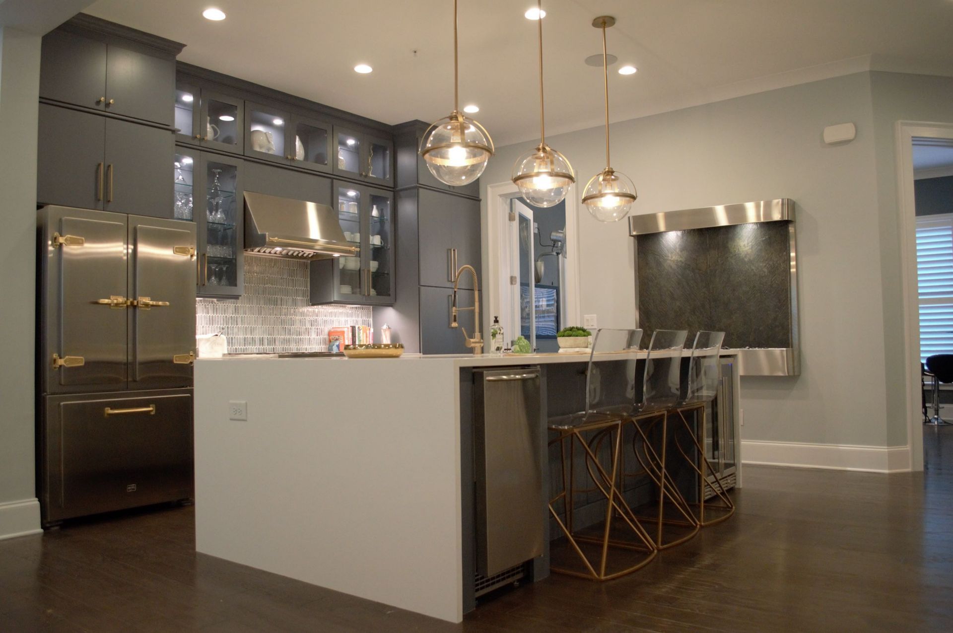 A kitchen with stainless steel appliances and a large island.