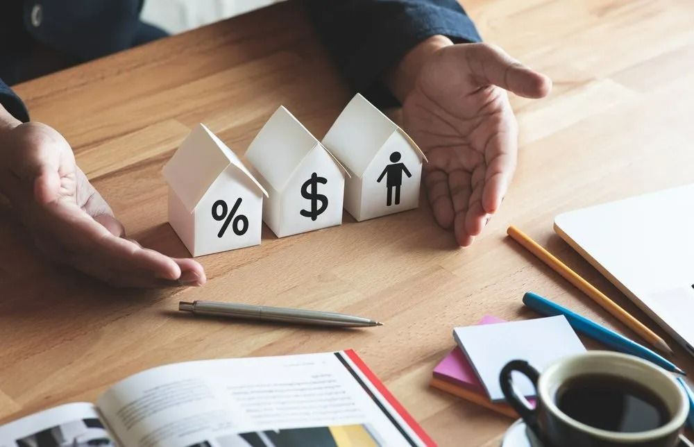 Hands Cupping Miniature Houses with Percent, Dollar, and Person Icon — All Finanz & Insurance Solutions Mackay in Bowen, QLD