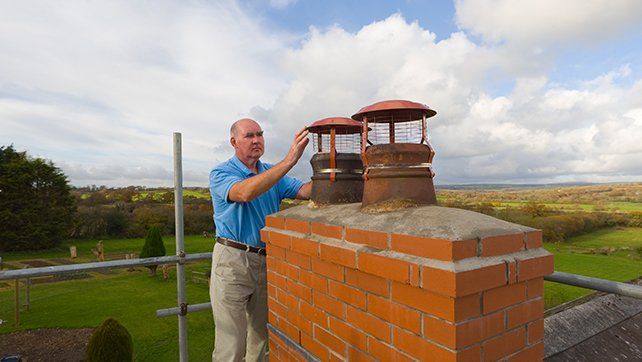 Man Inspecting Chimney — Livermore, CA — Charlie Dunn & Sons Installed Brick Chimney — Livermore, CA — Charlie Dunn & Sons