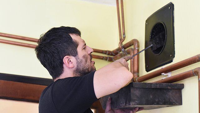 Man Cleaning Chimney — Livermore, CA — Charlie Dunn & Sons Man Cleaning Chimney — Livermore, CA — Charlie Dunn & Sons