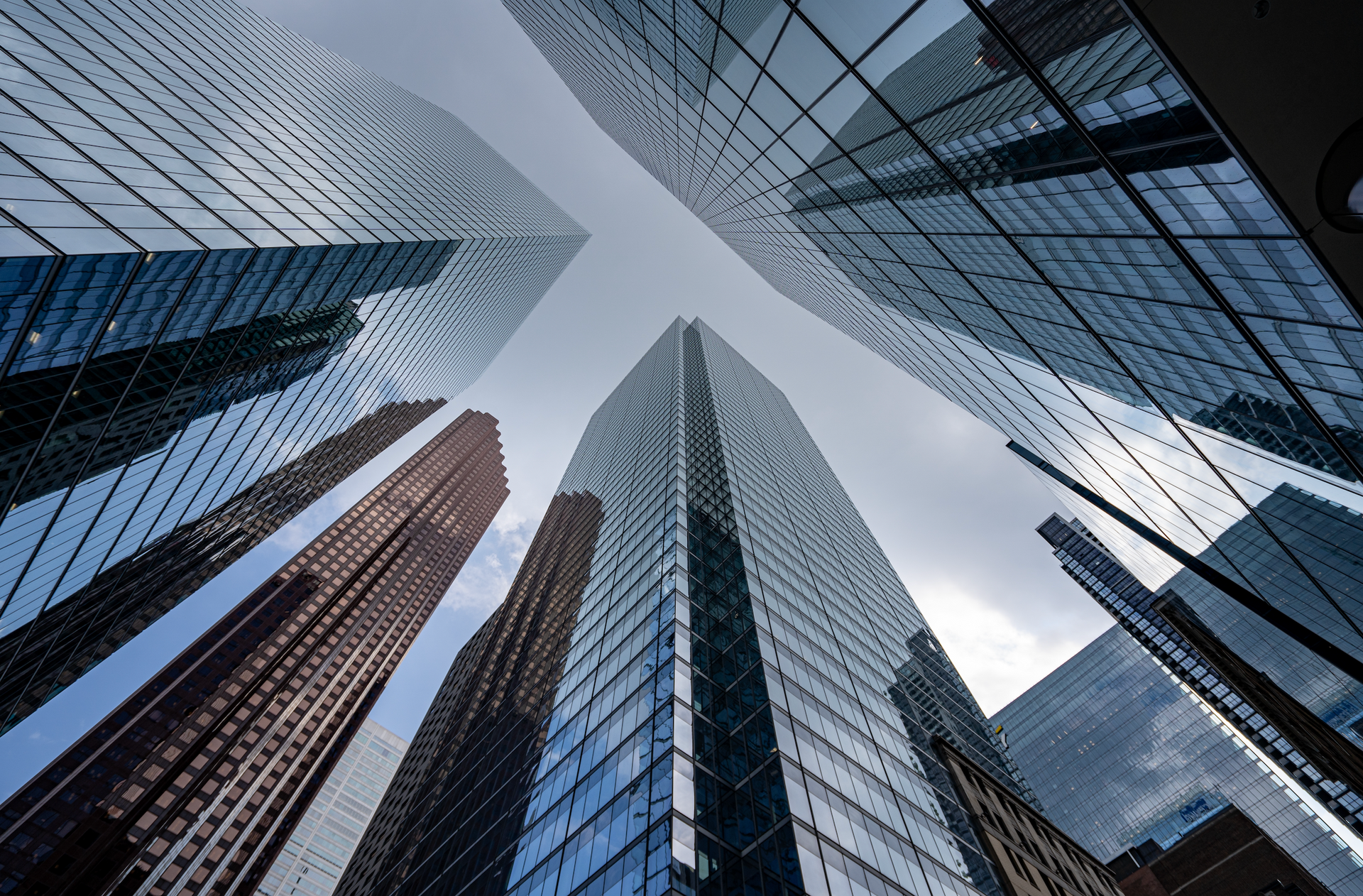 Looking up at a group of tall buildings in a city.
