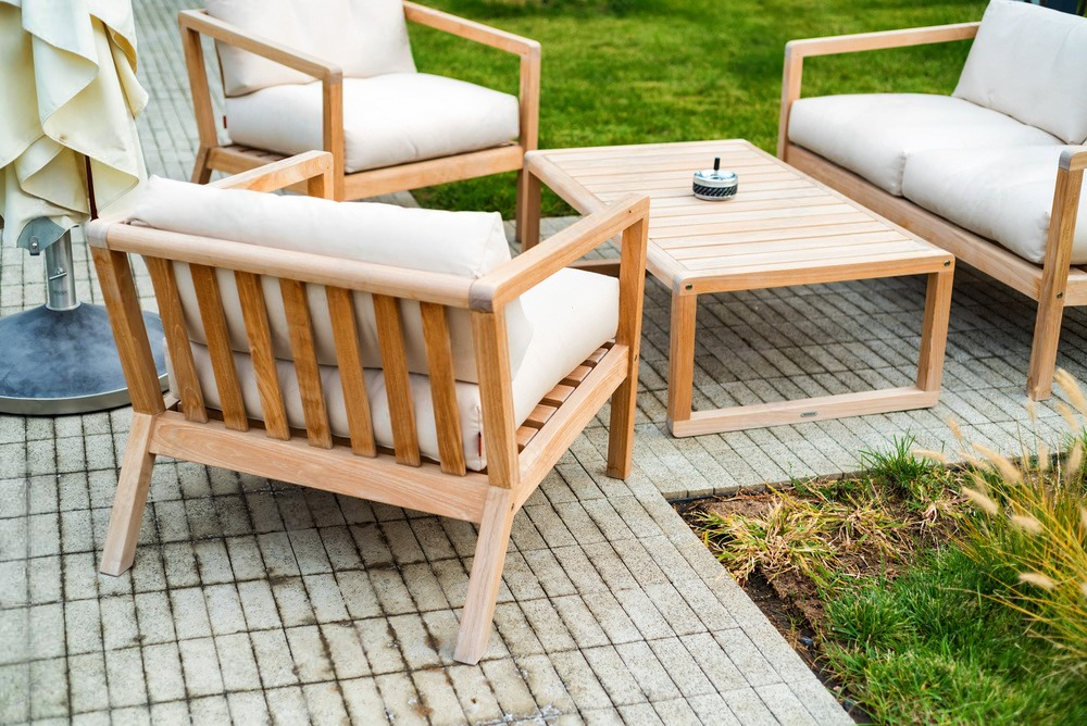 a wooden patio set with a couch , chairs , and a table .