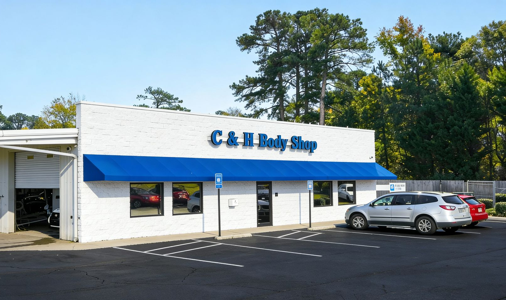 C&H Body Shop building with blue awning, parked cars, and trees in background.
