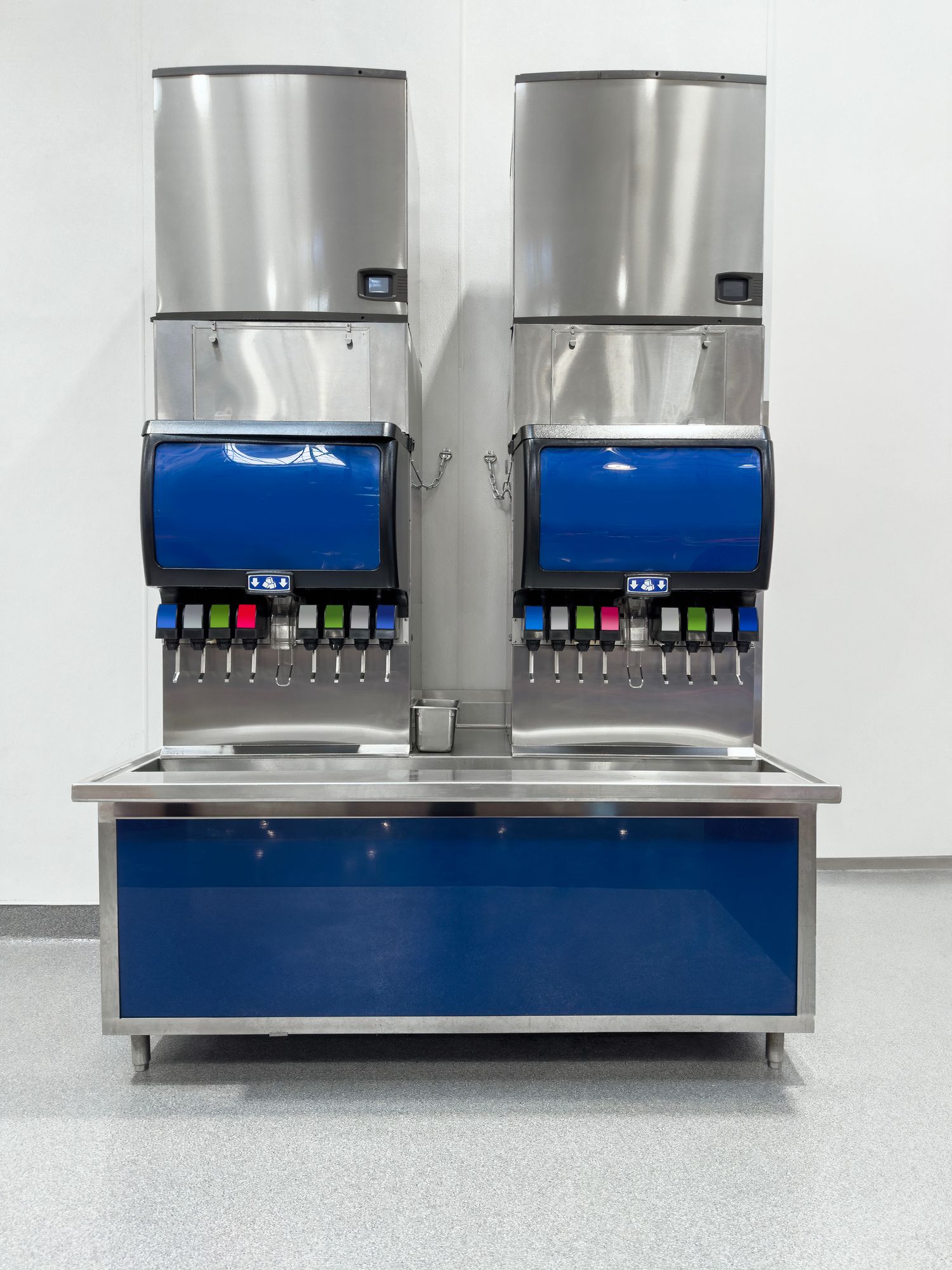 Two blue and stainless steel soda dispensers.