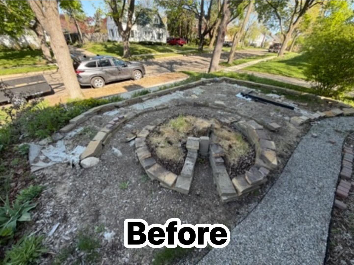Damaged circular concrete fire pit in a park, with broken stones and dirt around it