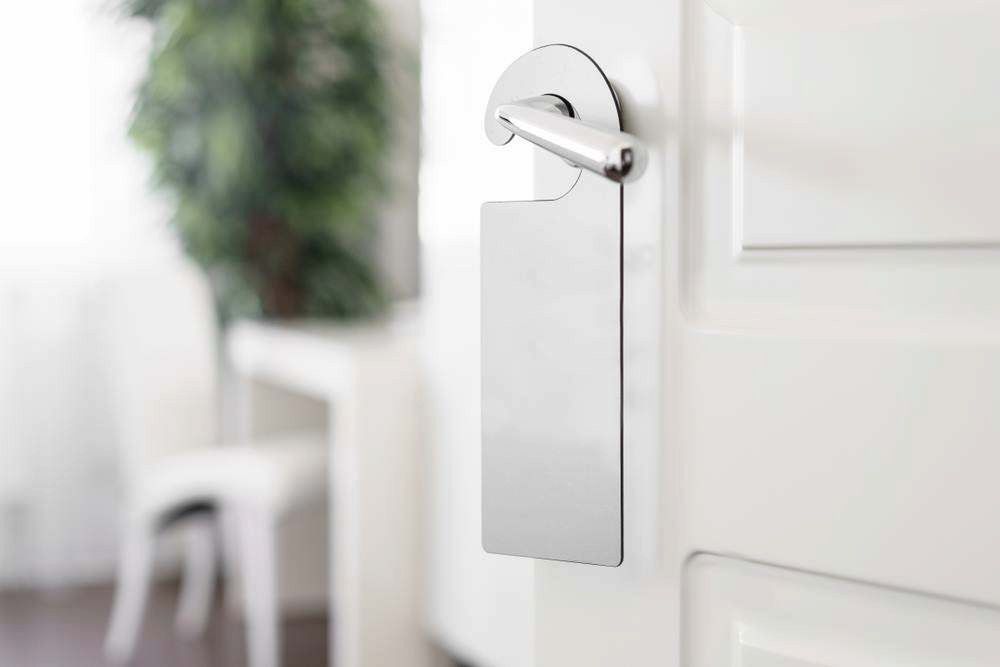 White Door Hanger on a Light-colored Door in a Bright Interior — Terrace Locksmiths in Raymond Terrace, NSW