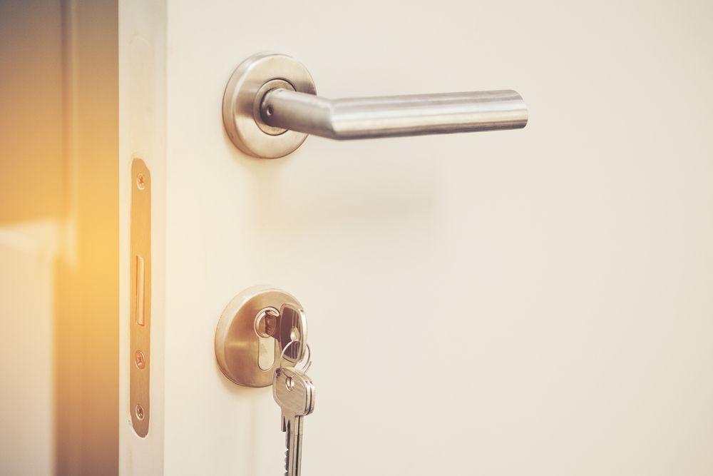 Interior Door with A Silver Handle and Key Inserted in The Lock — Terrace Locksmiths in Raymond Terrace, NSW