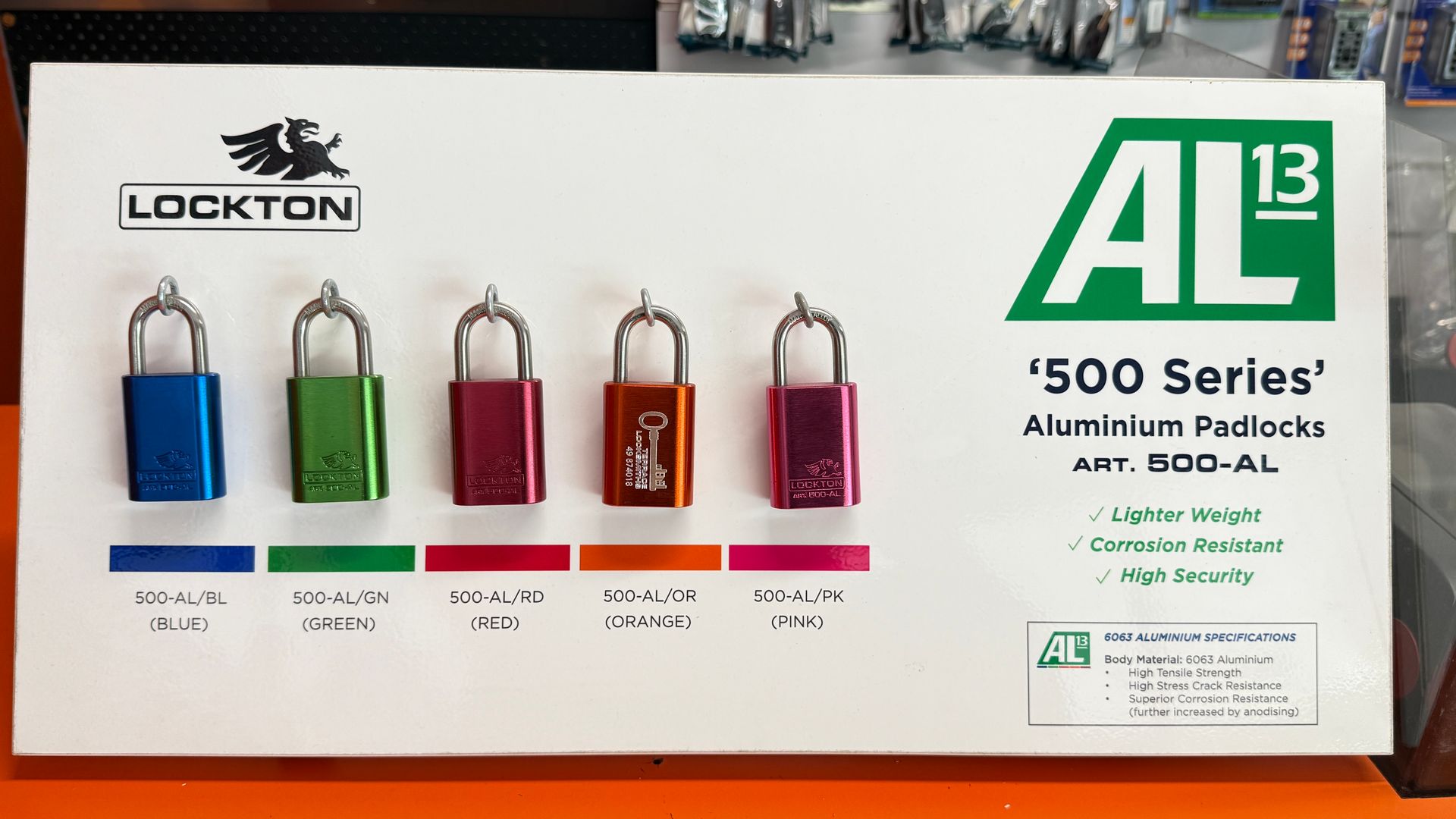 Lockton AL13 aluminum padlocks display board with five colorful locks: blue, green, yellow, orange, and pink. — Terrace Locksmiths in Raymond Terrace, NSW