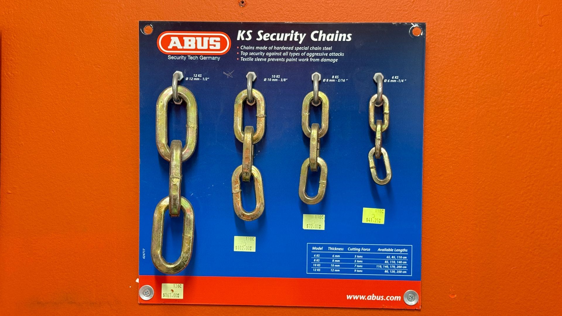 ABUS security chains displayed on a blue retail poster against an orange background — Terrace Locksmiths in Raymond Terrace, NSW