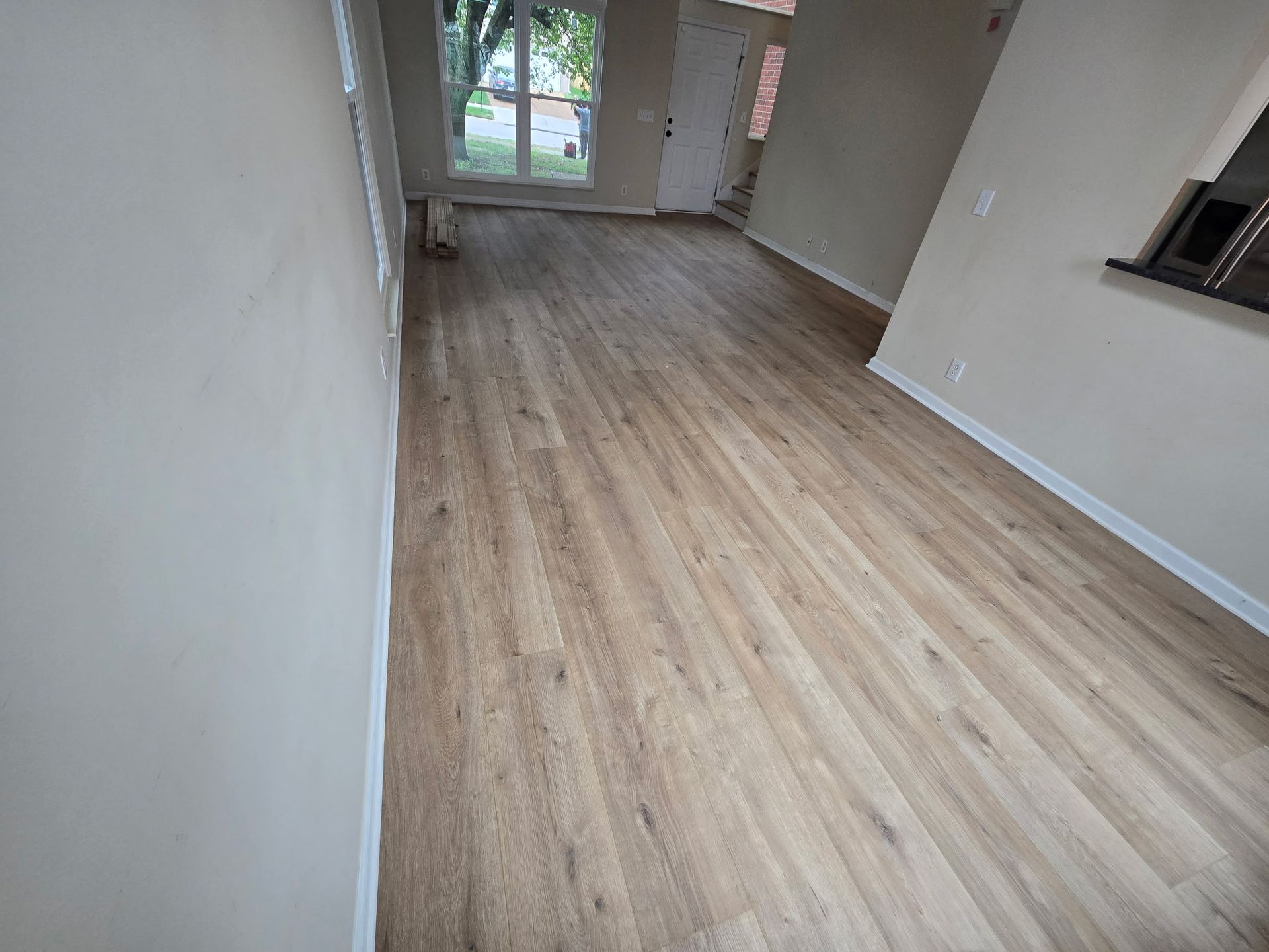 A living room with a wooden floor and white walls.