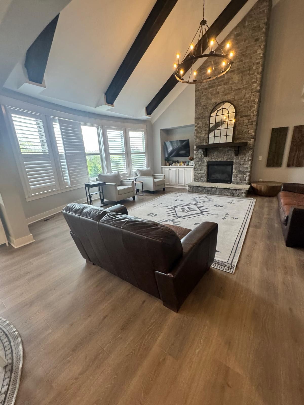 A living room with a couch , chairs , and a fireplace.