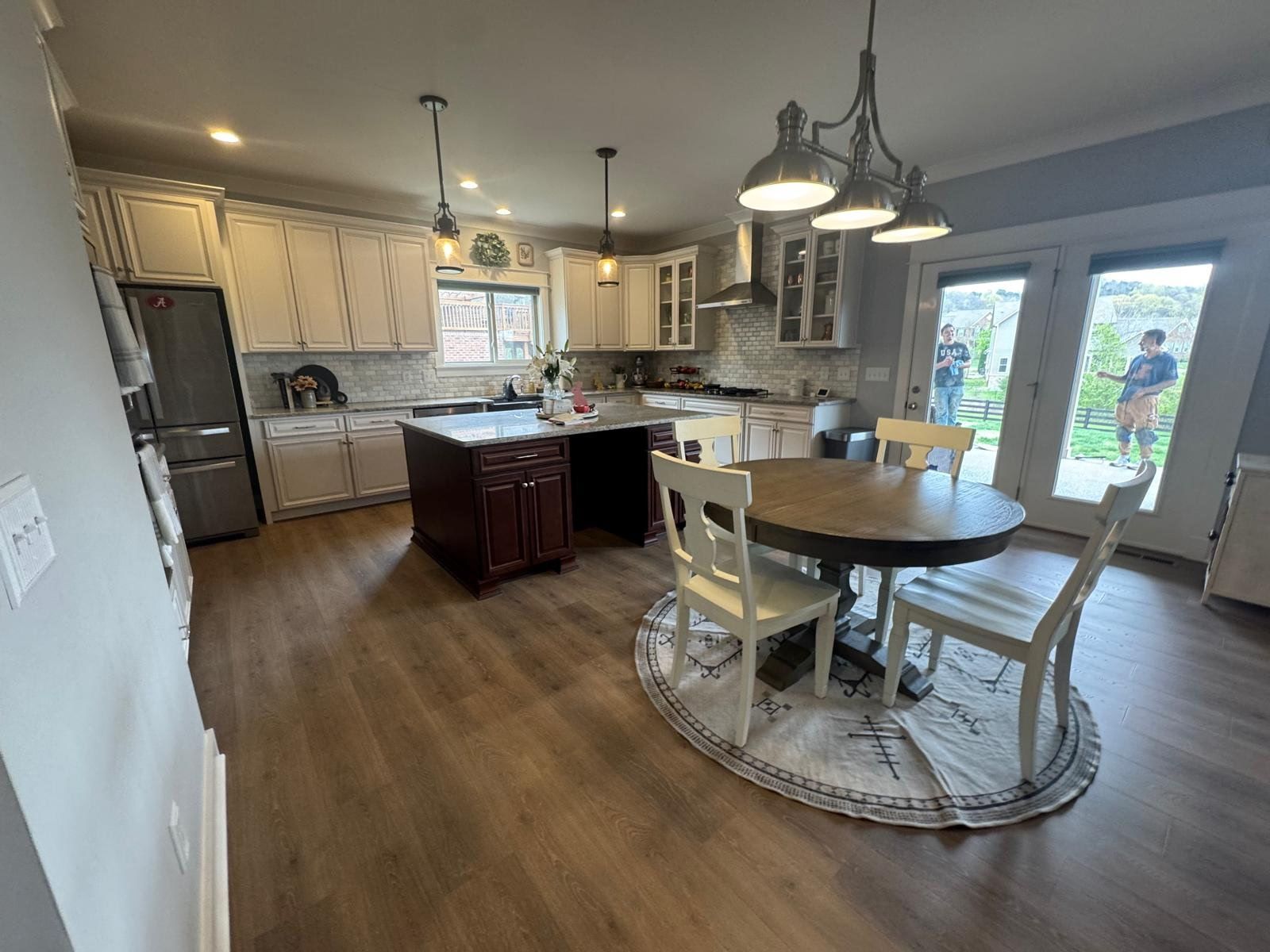 A kitchen with a table and chairs in it.
