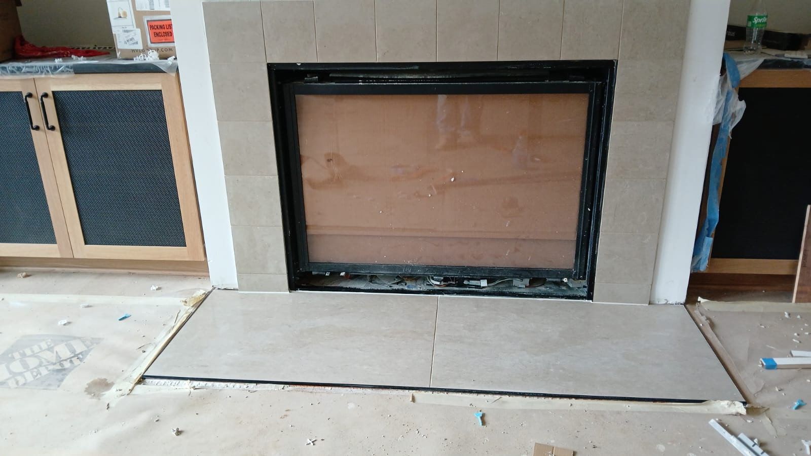 A fireplace is being remodeled in a living room