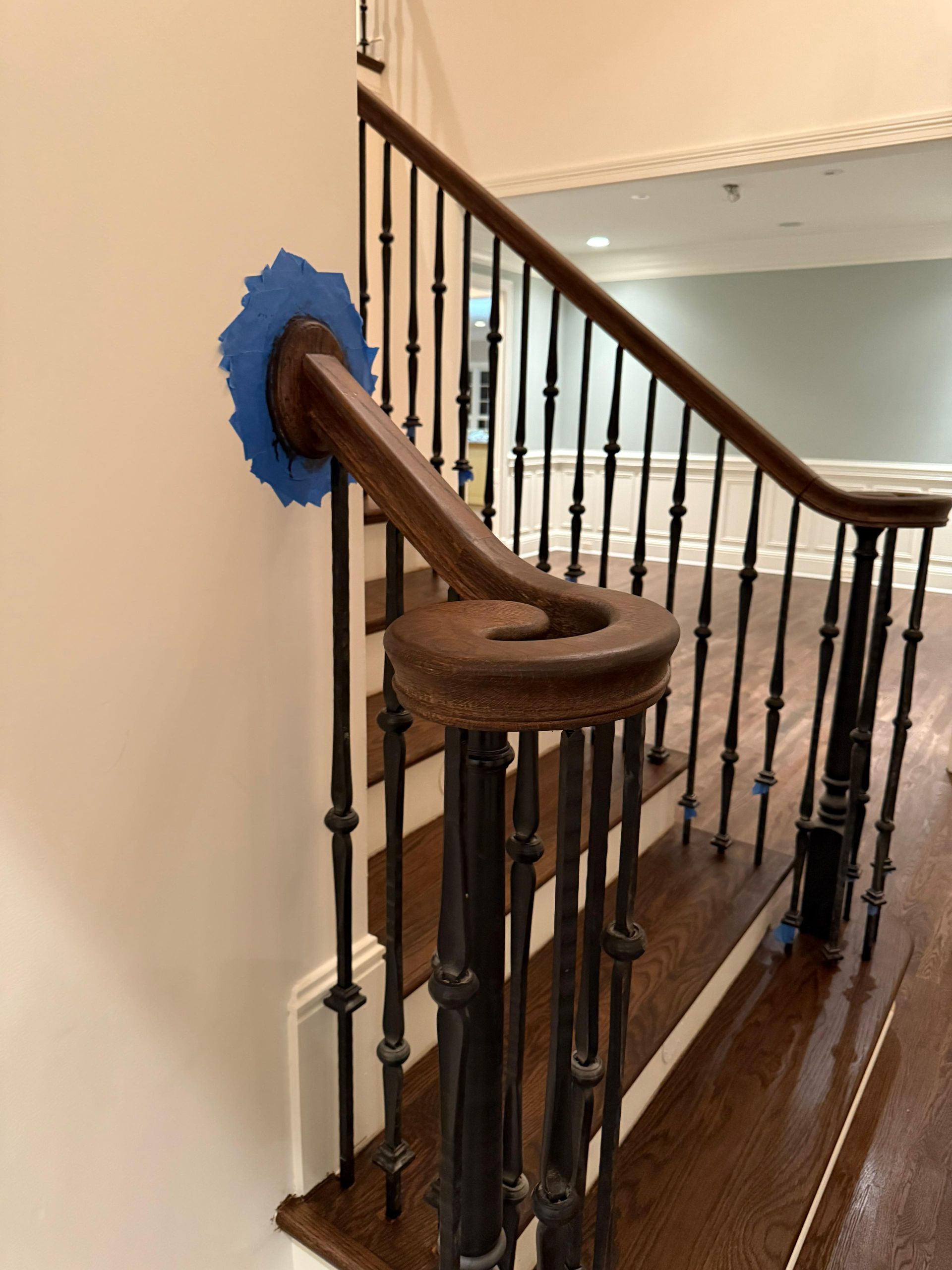 Wooden handrail and stair chair lift beside a staircase in a home interior