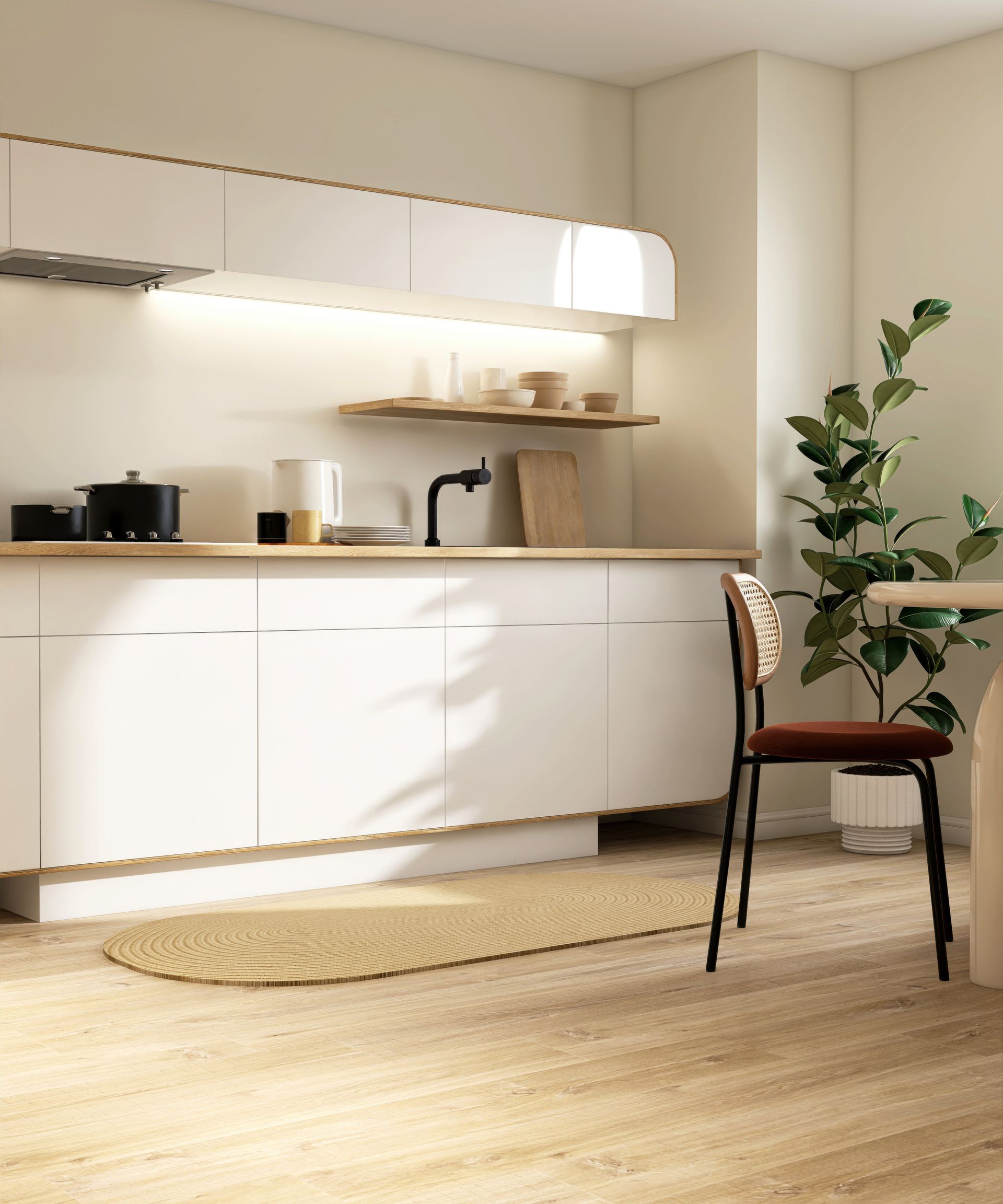 Modern white kitchen with wooden countertops, plants, and a chair.
