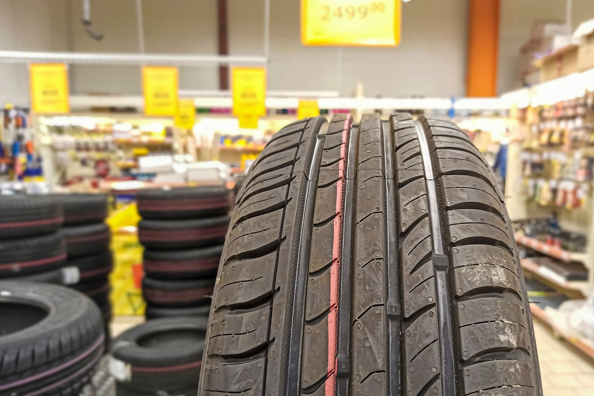 Close-up of a car’s tire inside a car parts store. Close-up of a car’s tire inside a car parts store.