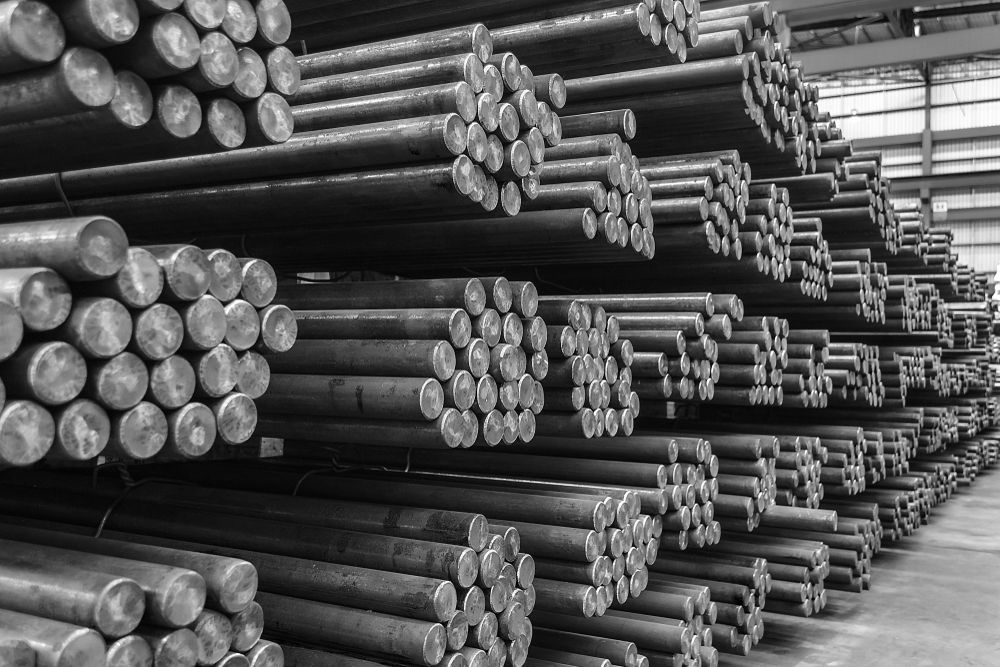 A Bunch of Metal Rods Are Stacked on Top of Each Other in a Warehouse — Top End Steel Supplies Darwin In Kununurra, WA