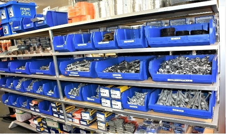 A Warehouse Filled With Lots of Blue Bins Filled With Screws and Nails — Top End Steel Supplies Darwin In NT