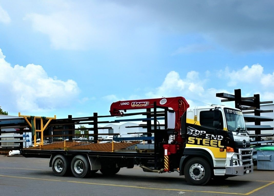 A Truck With the Word Steel on the Side is Parked in a Parking Lot — Top End Steel Supplies Darwin In Pinelands, NT