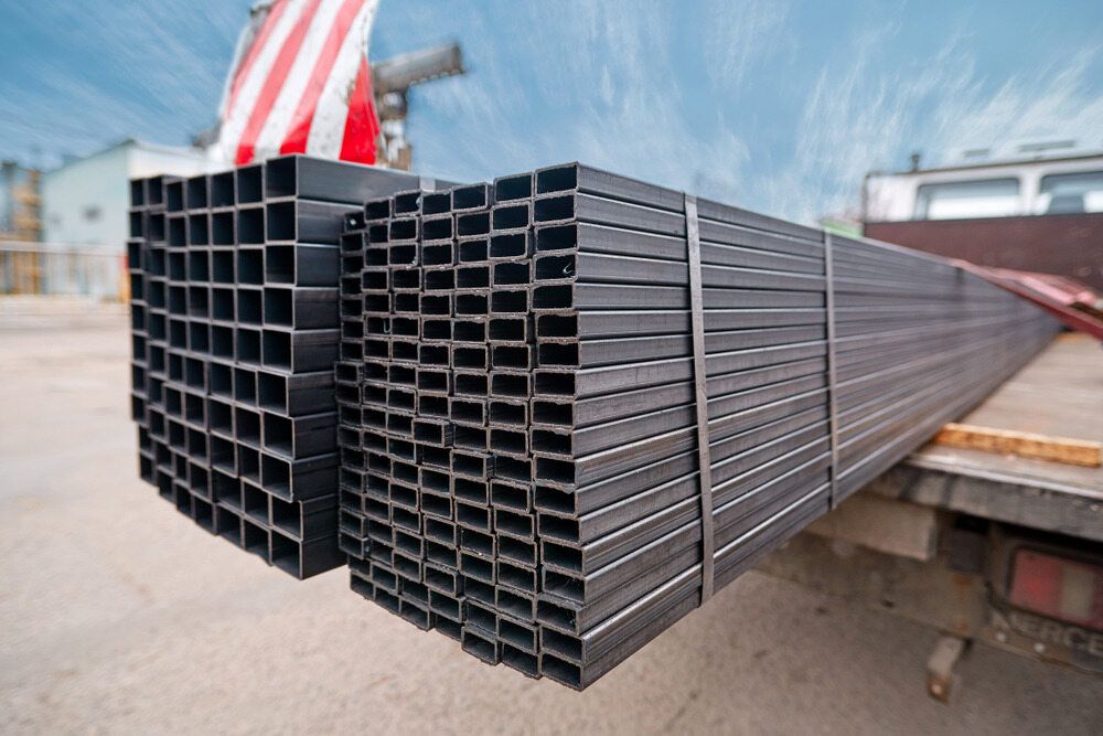A Stack of Metal Pipes Sitting on Top of a Truck — Top End Steel Supplies Darwin In NT