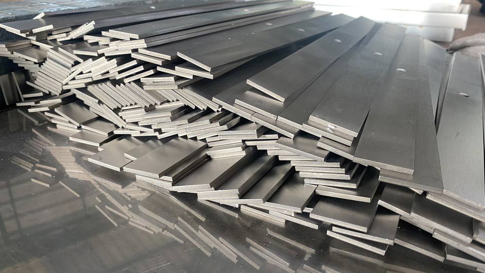 A Pile of Stainless Steel Bars Are Stacked on Top of Each Other — Top End Steel Supplies Darwin In Pinelands, NT