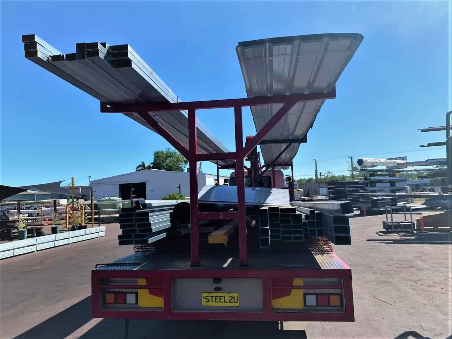 A Red Truck Carrying Steels — Top End Steel Supplies Darwin In Pinelands, NT