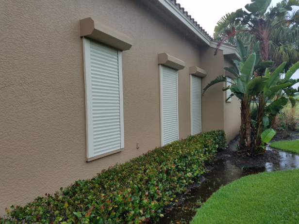 A house with a row of windows with shutters on them