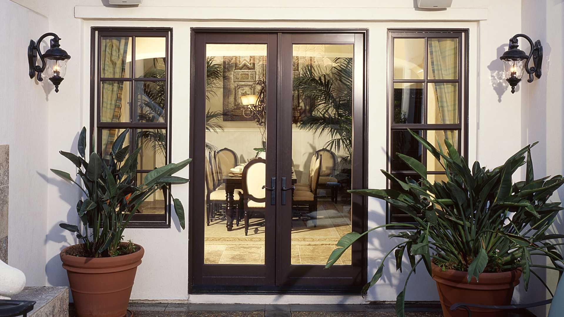 a patio with potted plants in front of a door