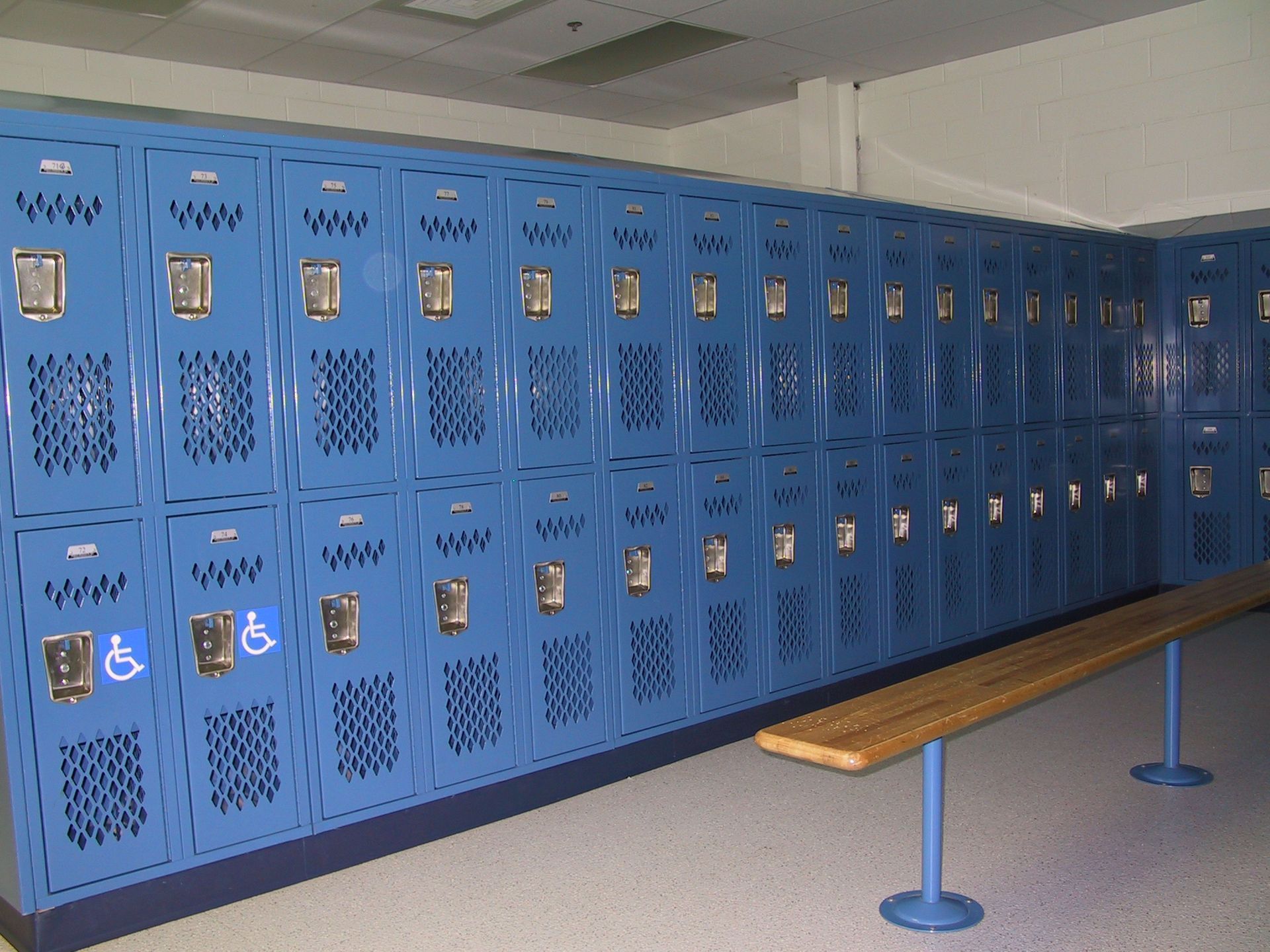 A row of blue lockers with handicap signs on them