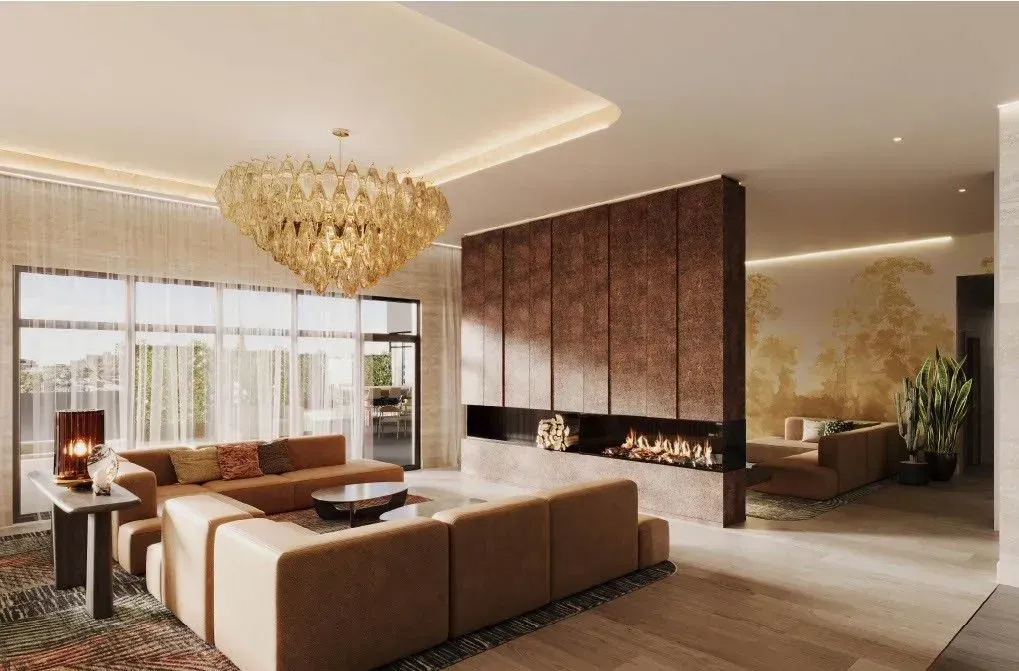 A living room with a couch , fireplace , and chandelier.
