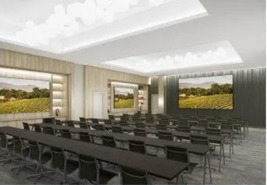 An artist 's impression of a conference room with long tables and chairs.