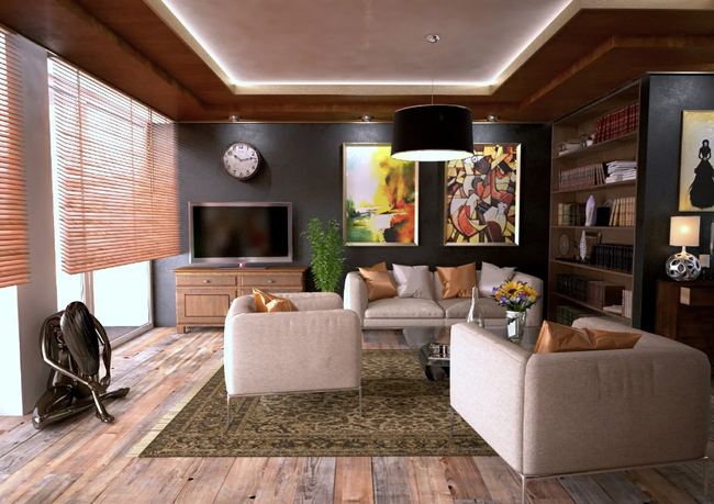 Modern living room with beige sofas, wood walls, large artwork, TV, and green rug