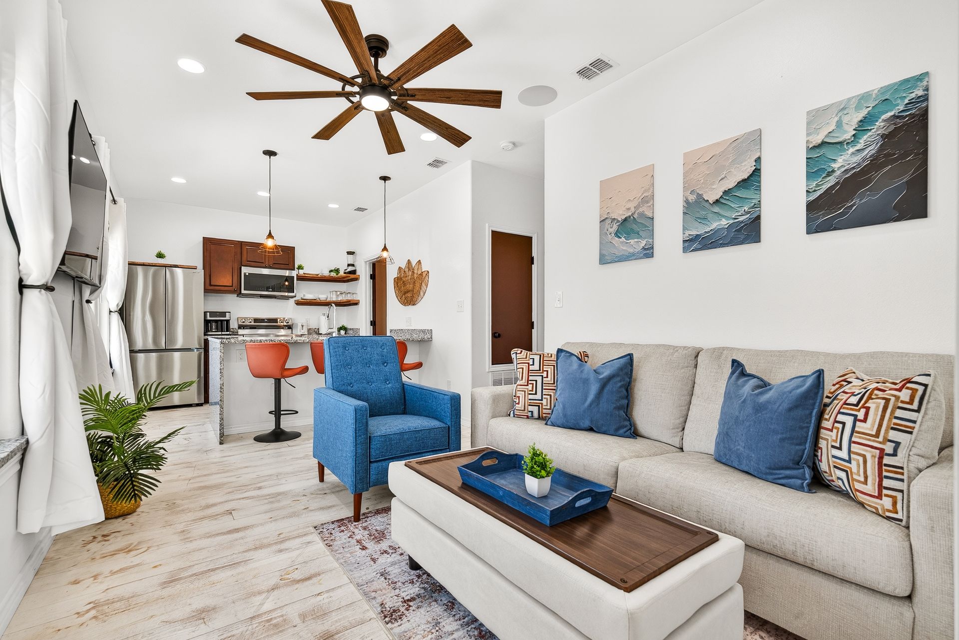 Port A Luxe I living room with coastal seating and an open kitchen
