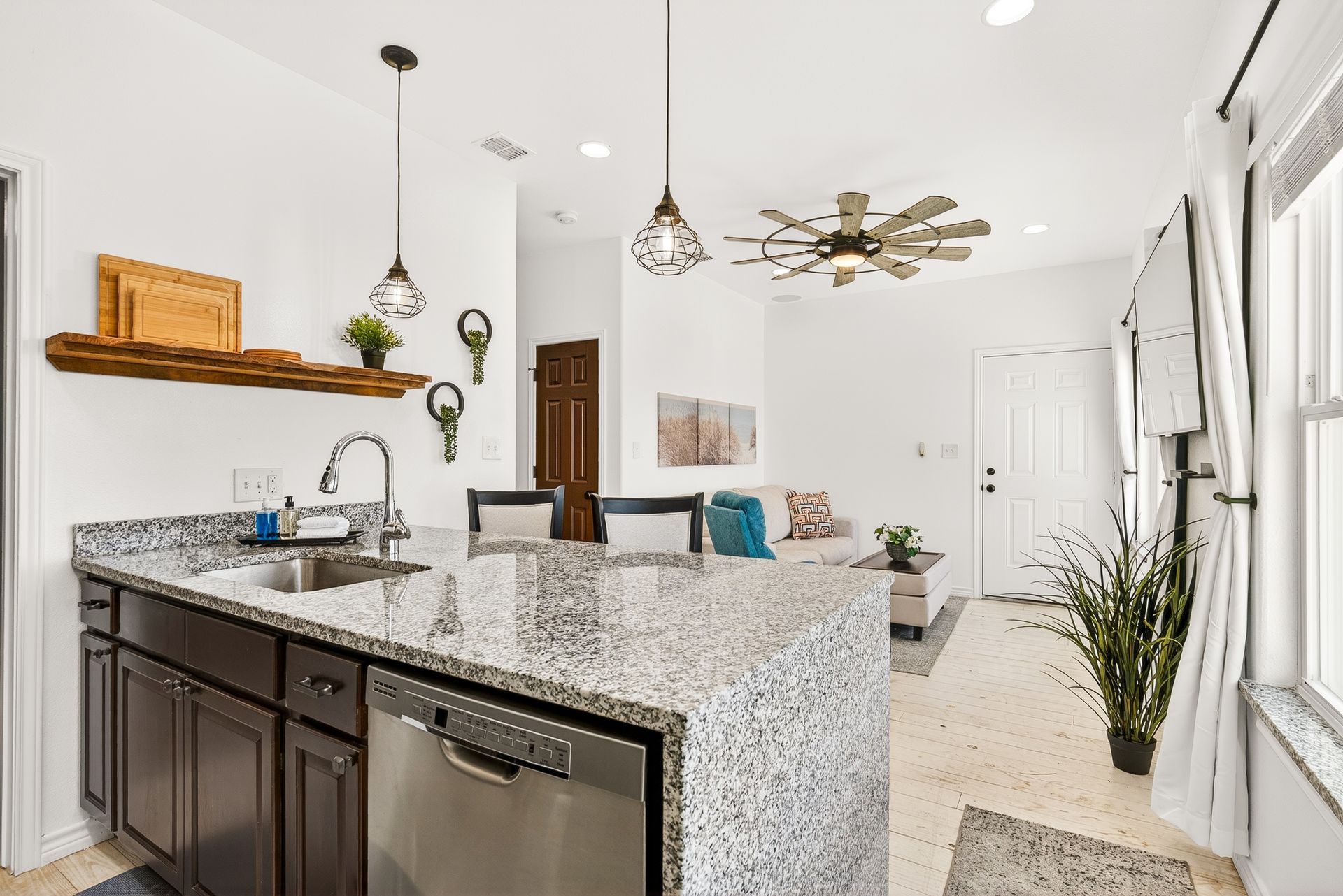 Open-plan kitchen with breakfast bar overlooking the living area