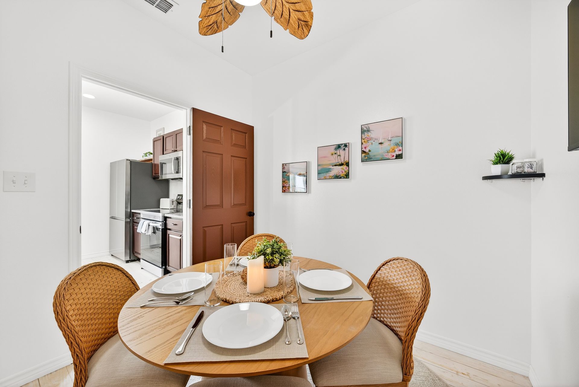 Dining table set for a meal beside the kitchen