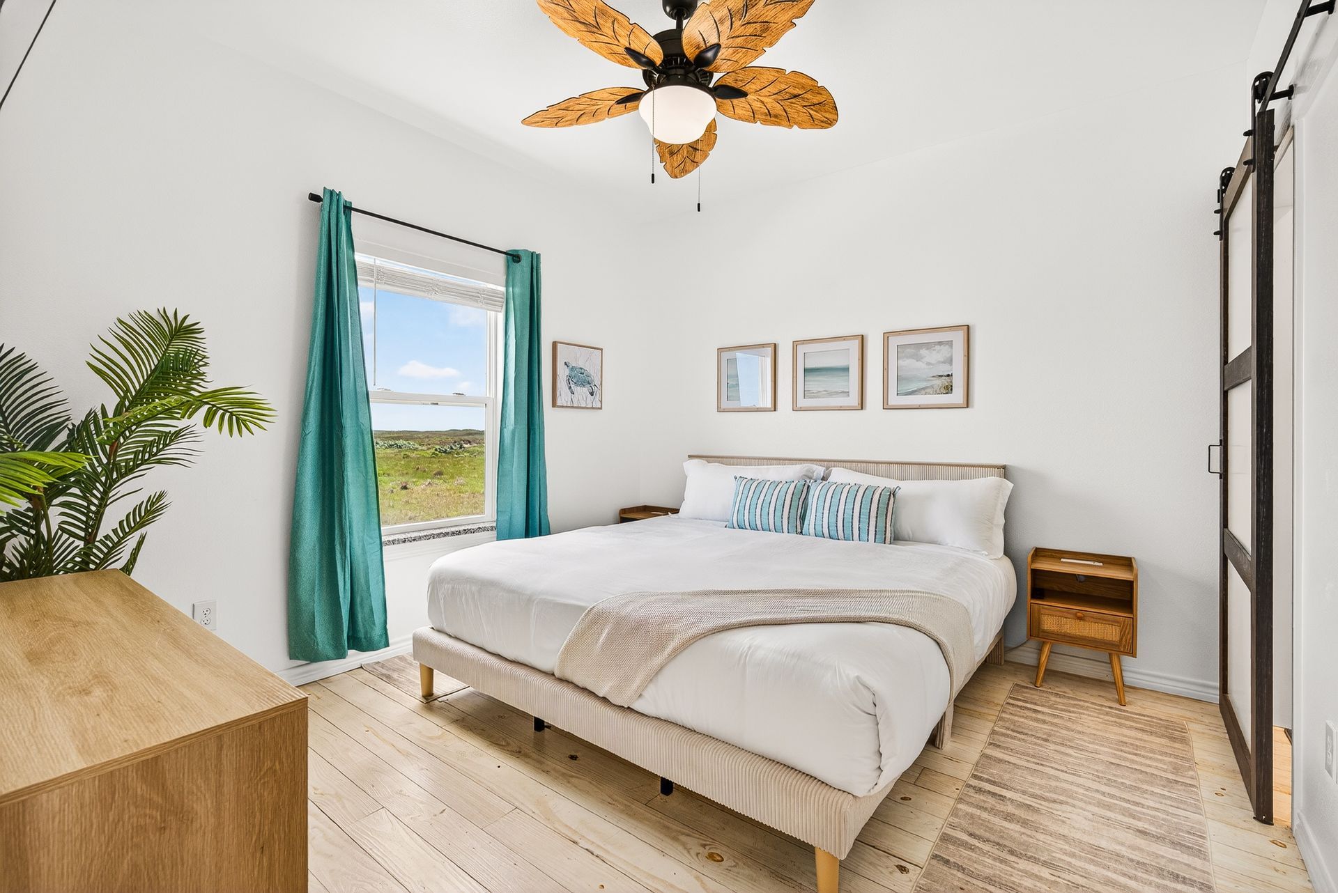 King bedroom with coastal decor and natural light