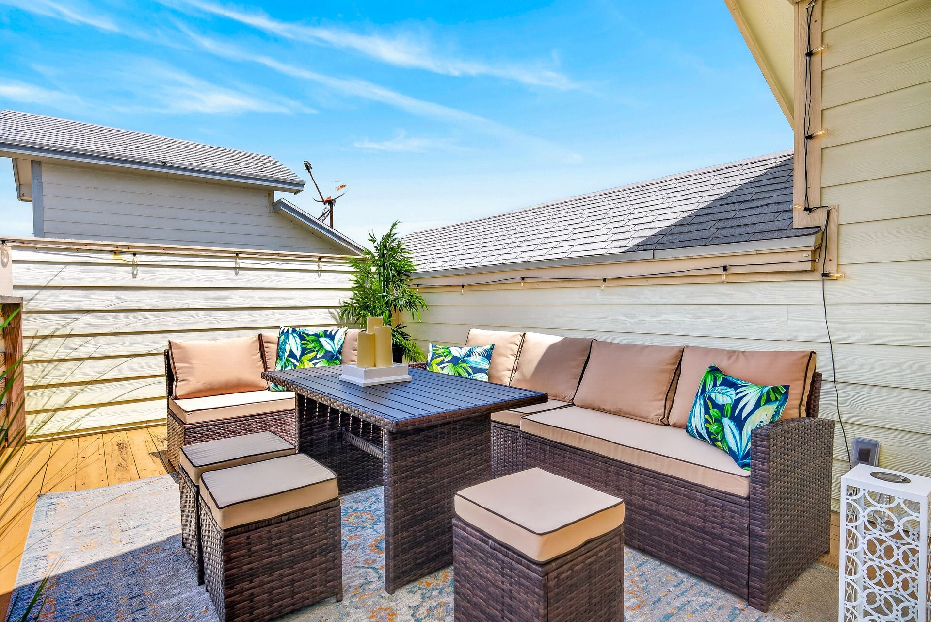 Rooftop lounge with coastal seating beneath an open blue sky
