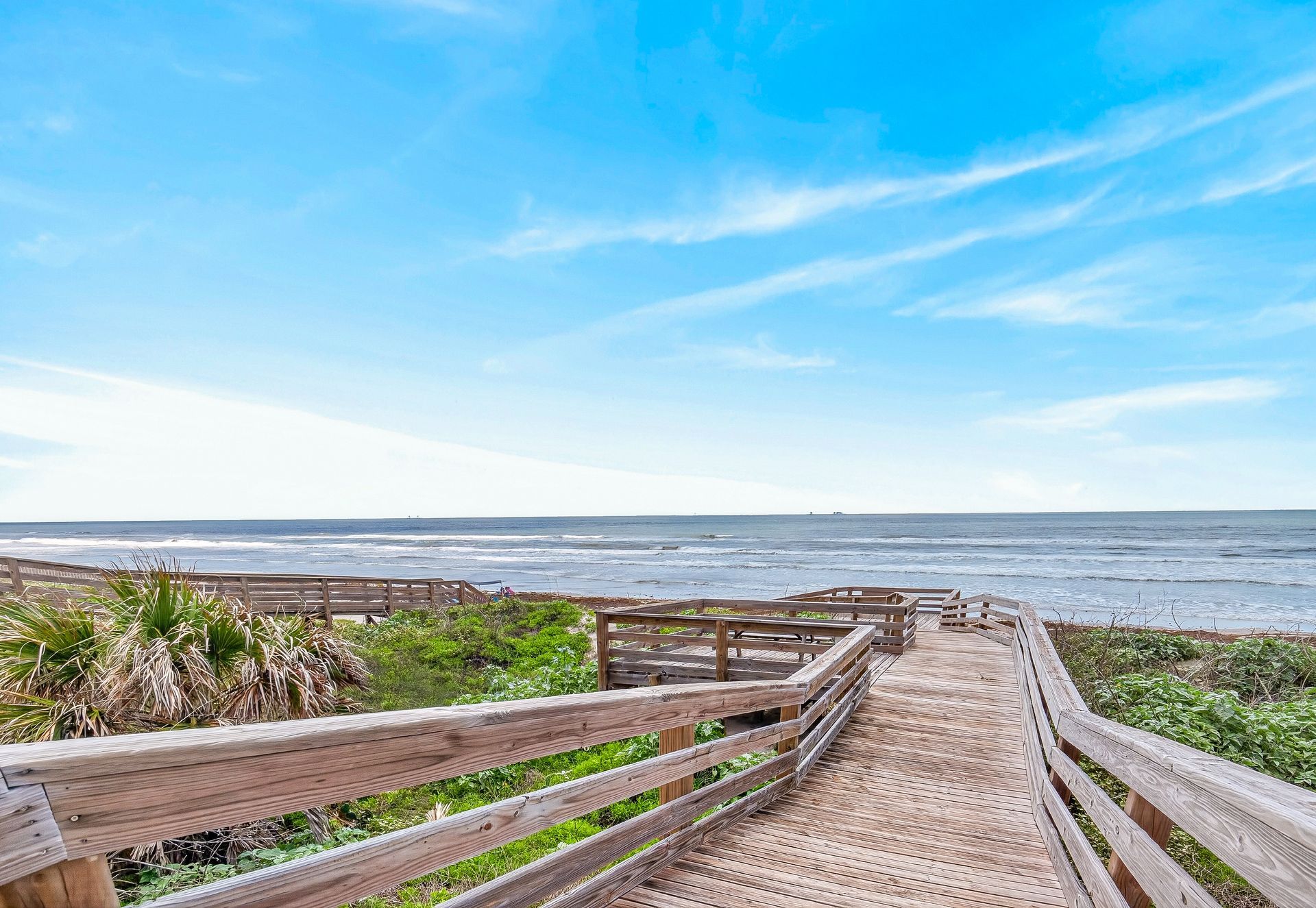 Private wooden boardwalk crossing the dunes to the Gulf beach