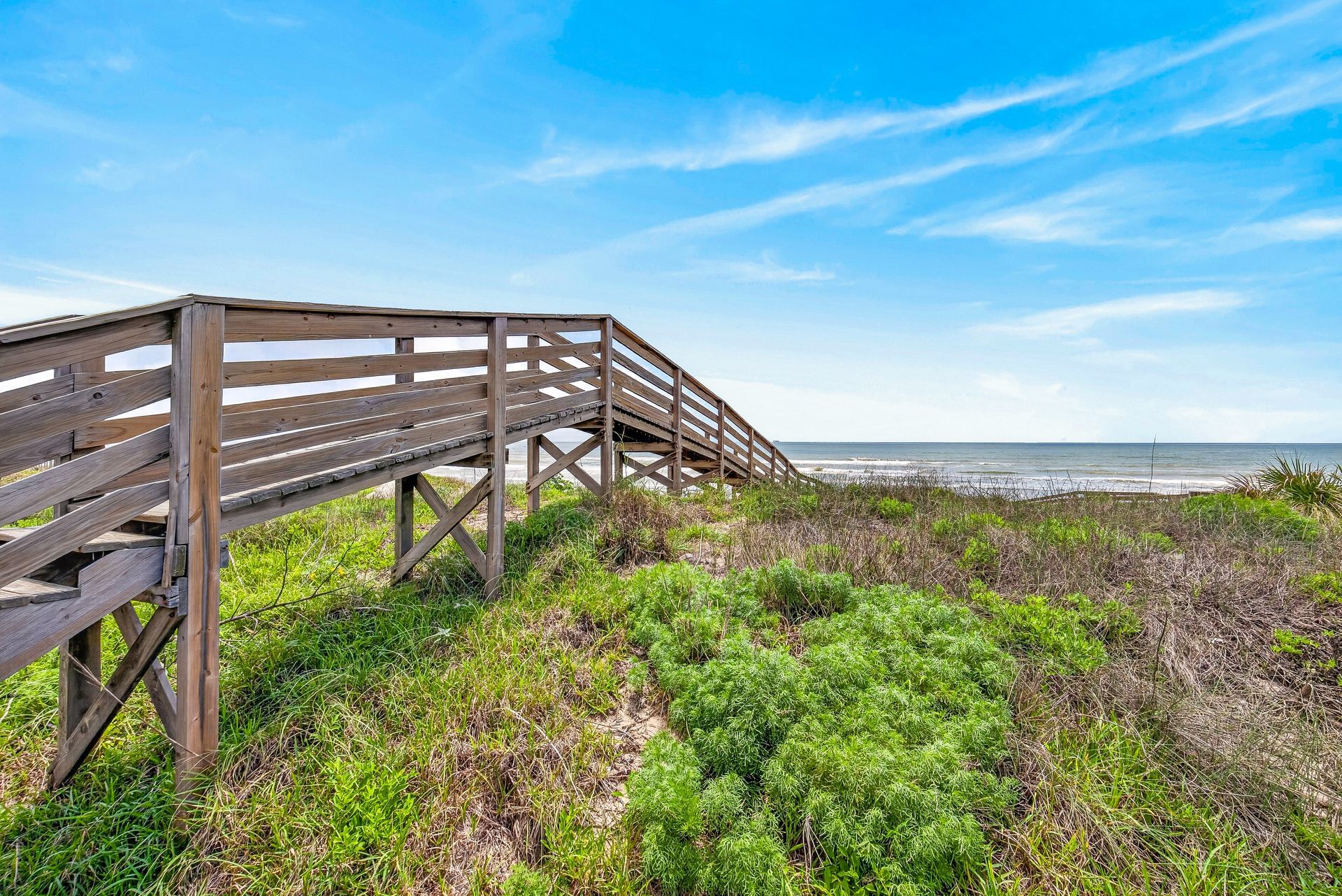 Private boardwalk crossing coastal dunes toward the Mustang Island beach
