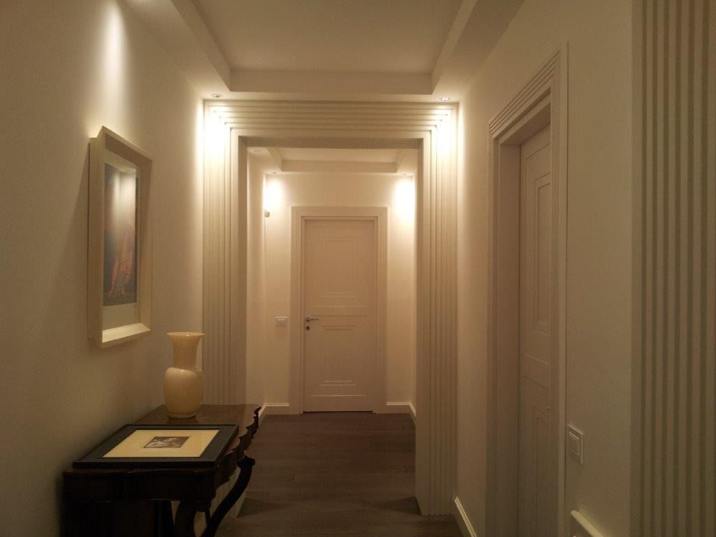 Corridoio con pareti beige con personalizzazioni in legno.