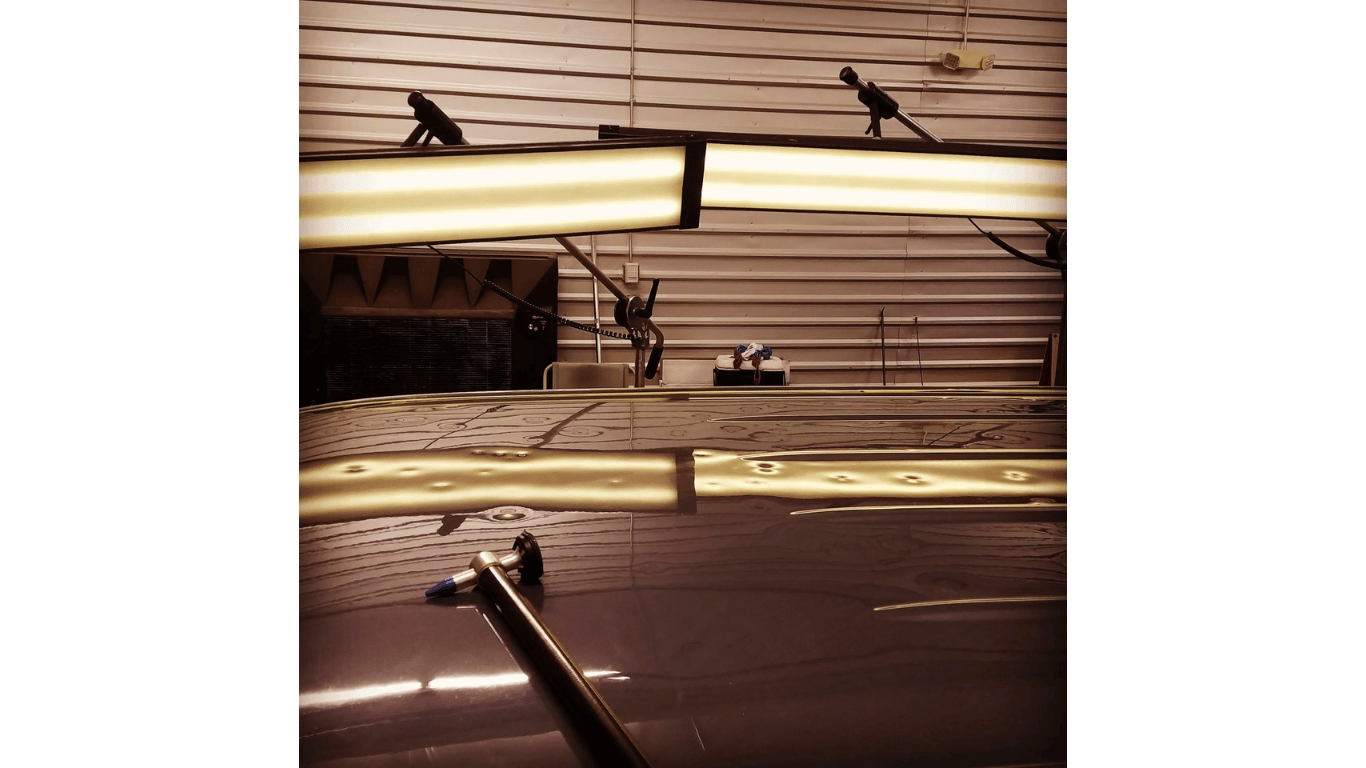 Ceiling with fluorescent lights, wiring, and small bird silhouettes in an industrial interior