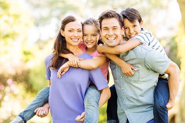 Family smiling and posing for picture
