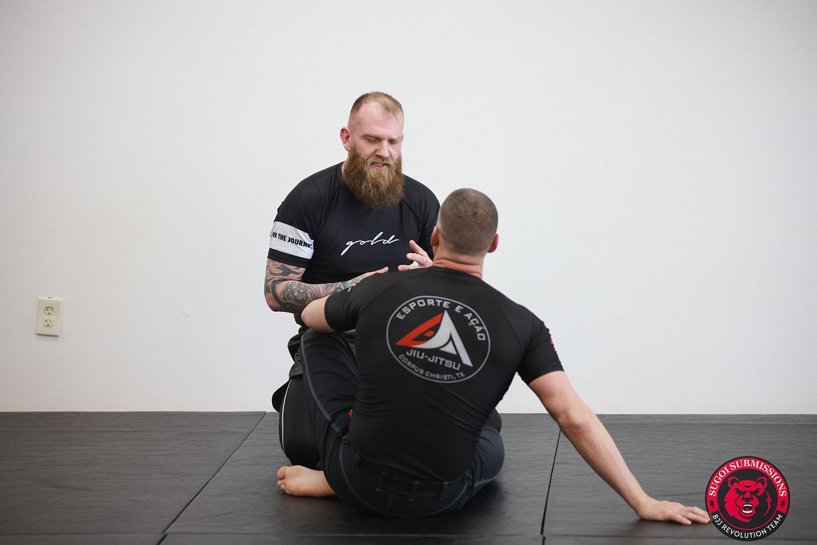 Adults drilling Brazilian Jiu-Jitsu techniques at Sugoi Submission in Corpus Christi, Texas.