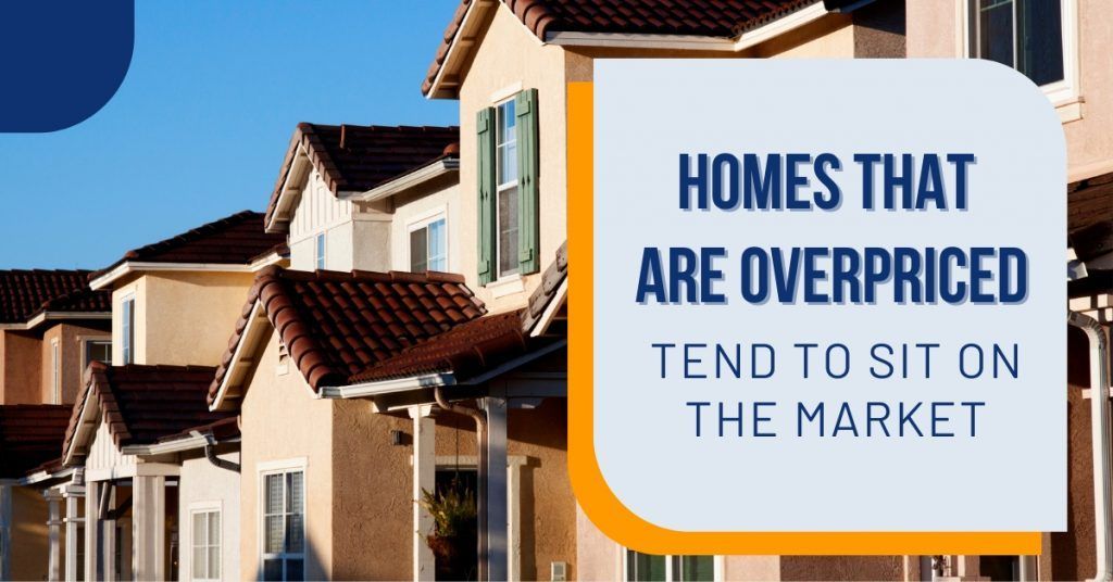Row of suburban homes beside sign reading “Homes that are overpriced tend to sit on the market”