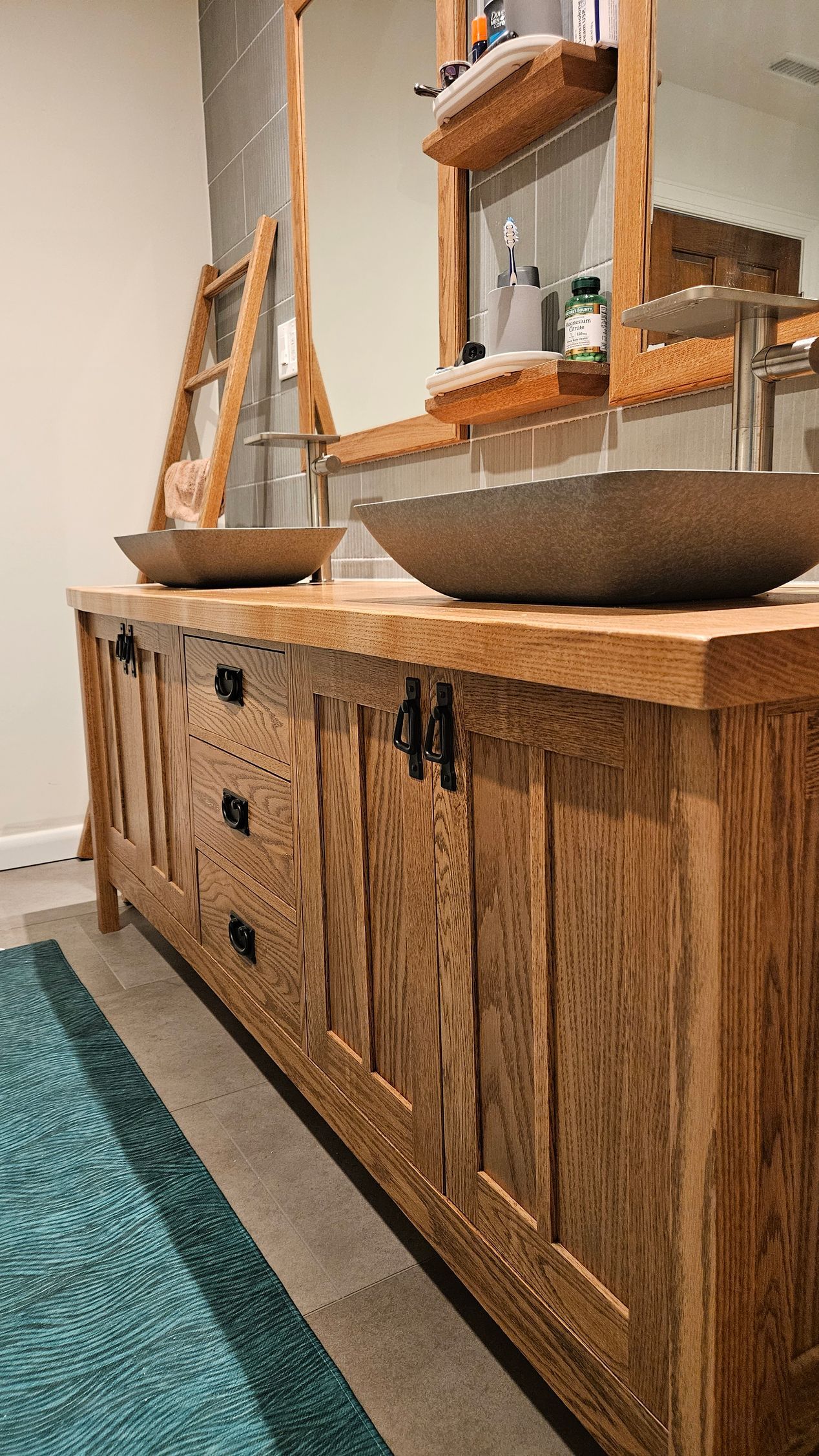 Rustic wooden cabinet with decorative bowls and a mirror in a bright interior room.